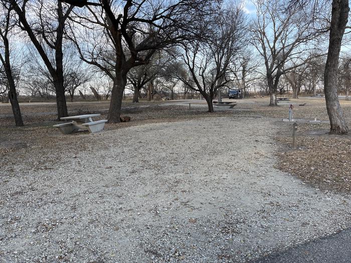 A photo of Site 025 of Loop RIVE at RIVERSIDE (KS) with Picnic Table, Electricity Hookup, Fire Pit, Shade, Water Hookup