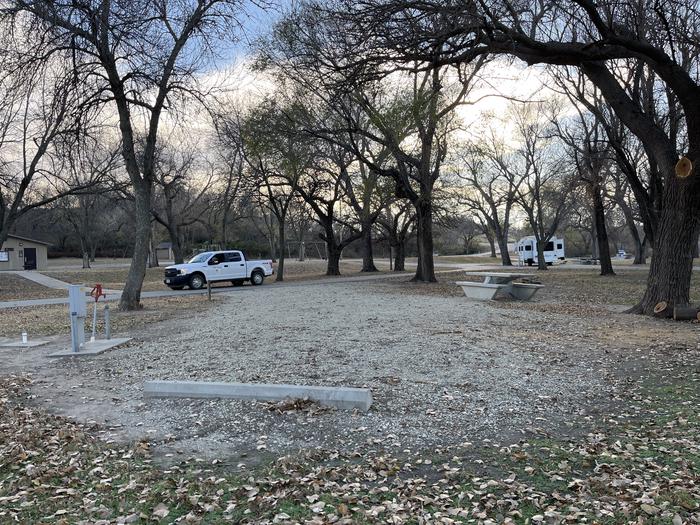 A photo of Site 025 of Loop RIVE at RIVERSIDE (KS) with Picnic Table, Electricity Hookup, Fire Pit, Shade