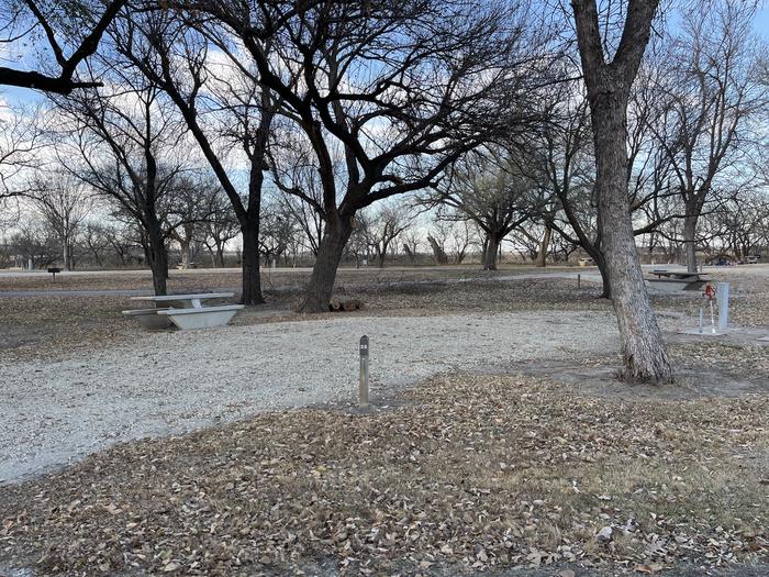 A photo of Site 025 of Loop RIVE at RIVERSIDE (KS) with Picnic Table, Electricity Hookup, Fire Pit, Shade, Water Hookup