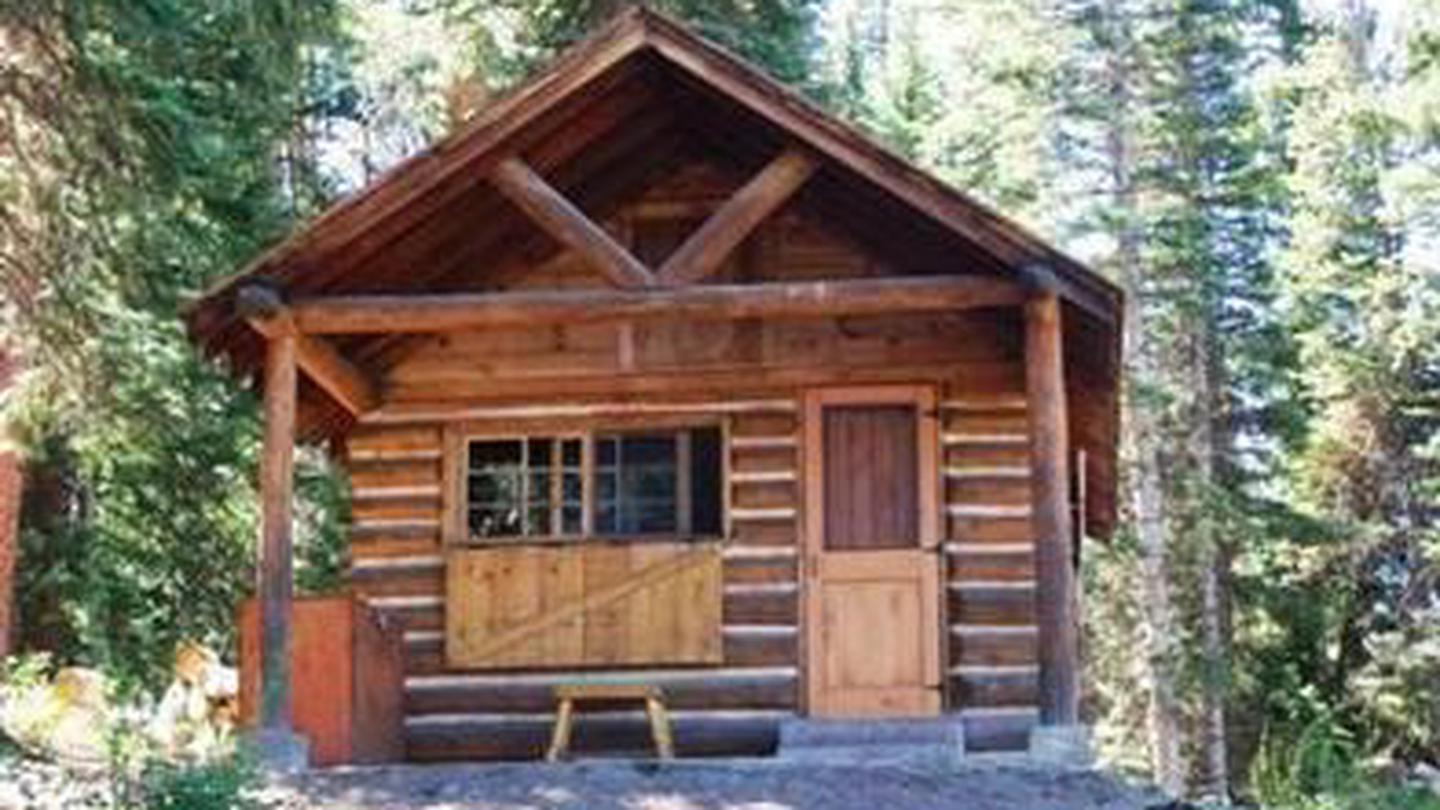 The front of a wooden cabin in a forestFront of cabin