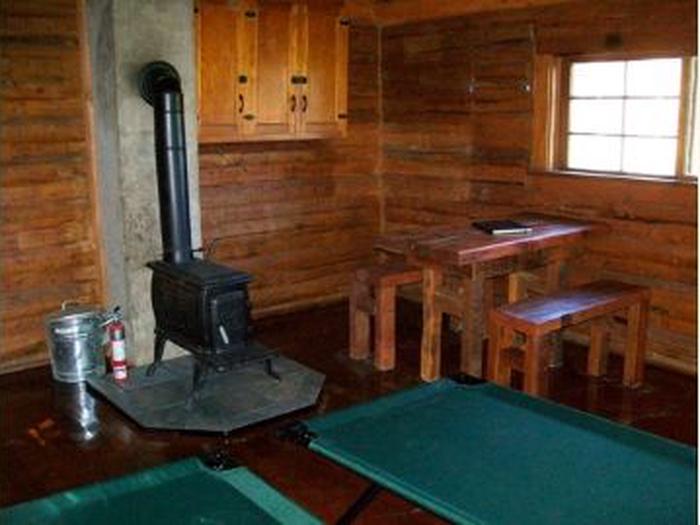A stove and other furniture inside a wooden cabinCabin interior