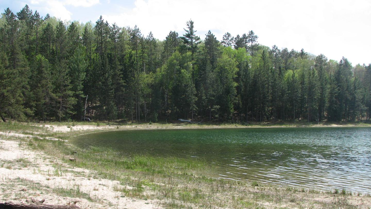 The view of the shoreline along Wagner Lake from the Wagner Lake Campground Beach.