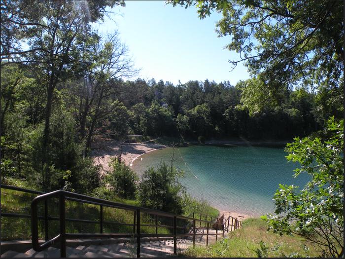 A view of Kneff Lake and the Kneff Lake Day Use area beach from a staircase. 