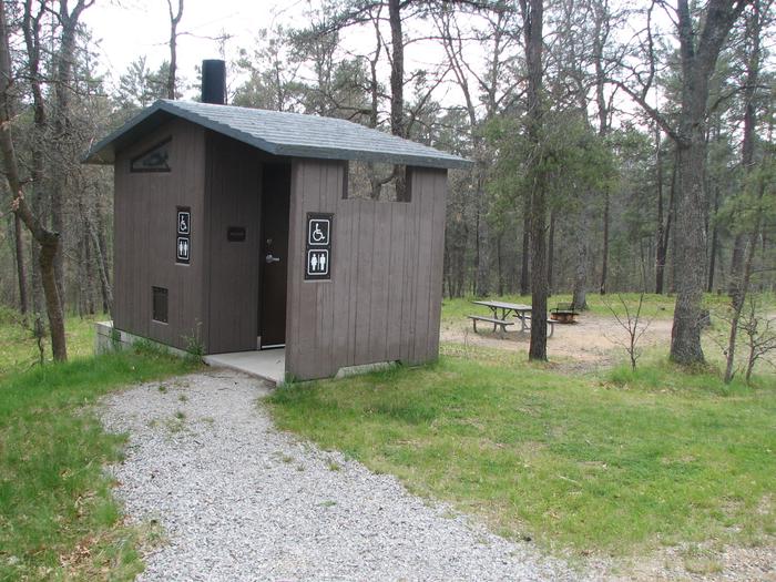 A vault toilet in the Kneff Lake Campground
