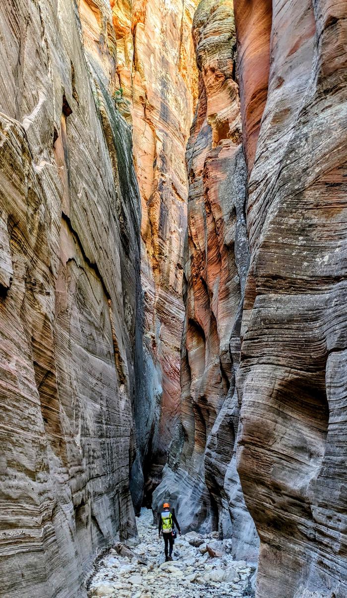 Canyoneer in slot canyon in ZionZion Canyoneering