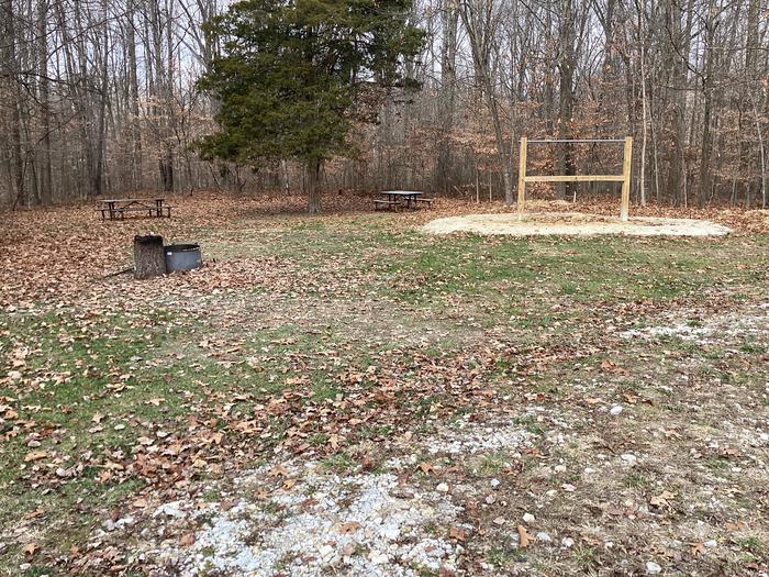 A photo of Site 3 at Hickory Ridge Campground with Picnic Table, Fire Pit, Shade, and Hitching Post.