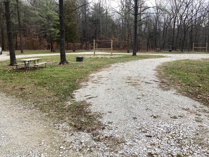 A photo of Site 6 of Loop Hickory Ridge Campground at Hickory Ridge Campground with Picnic Table, Fire Pit, Pull-through Parking, and Hitching Post.
