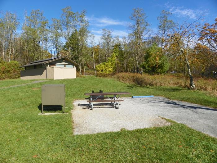 ADA site A63 - close to restroomAccessible campsite has a driveway, tent pad, picnic table, raised fire pit, and food storage box. 