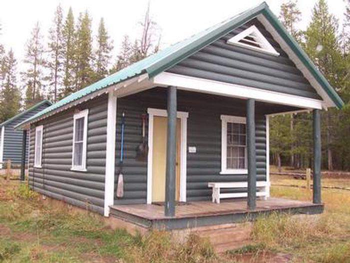 A wooden cabin with a porch in the woodsKelley Guard Station