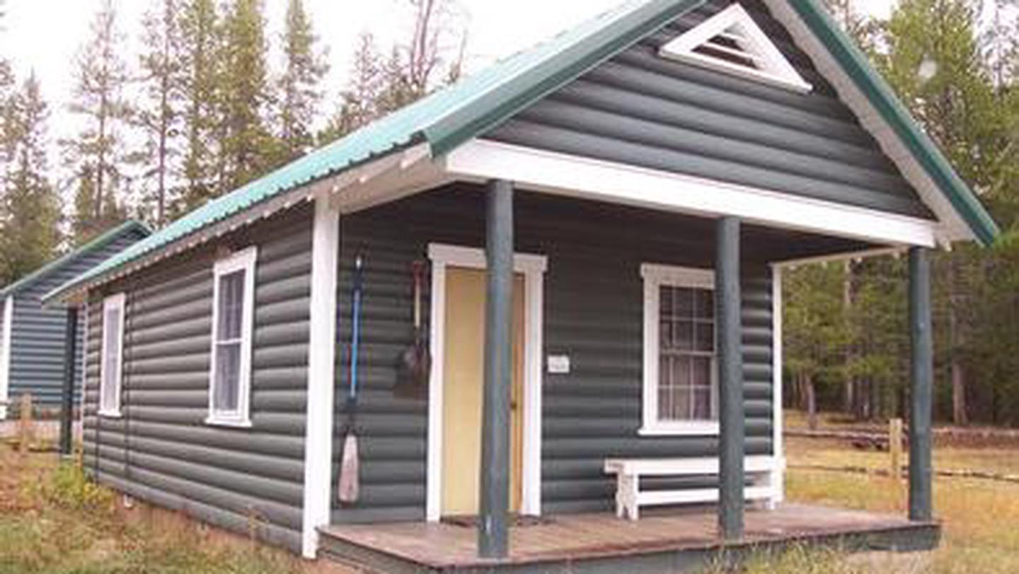 A wooden cabin with a porch in the woodsKelley Guard Station