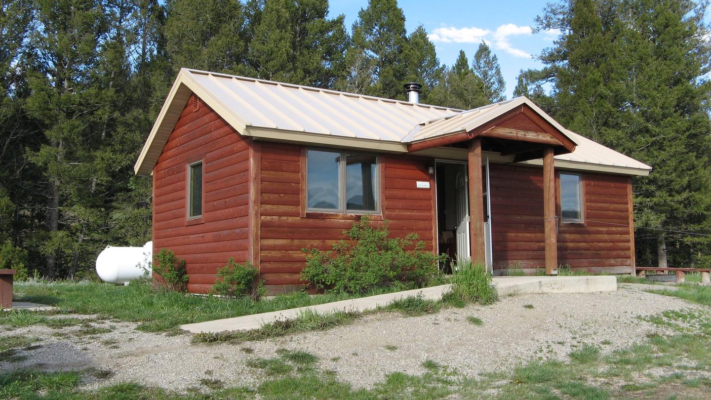 A red wooden cabin with two wingsCalf Creek Cabin