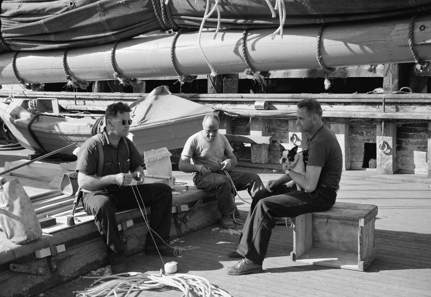 Museum founders working aboard CA Thayer Karl Kortum and two other museum sailors sitting on CA Thayer's hatch working 