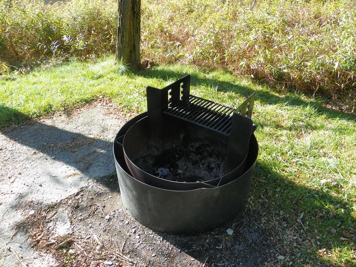 B111 fire pitAccessible site has a fire pit with double walls and a raised grill. 