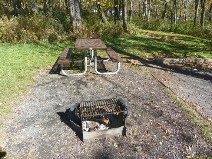 Campsite B 112Site has a driveway, tent pad, picnic table, and fire pit. 