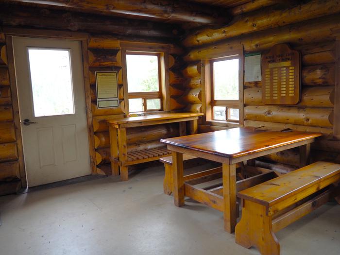 Middle Ridge Cabin interior with wood table and shelvesWrangell High School students built much of the furniture inside Middle Ridge Cabin.