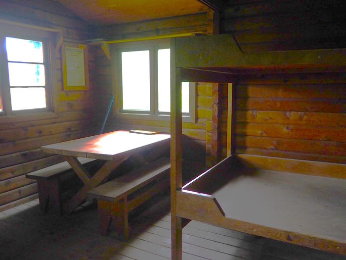 Sergief Island Cabin interior showing wood bunkbed and tableSergief Island Cabin interior