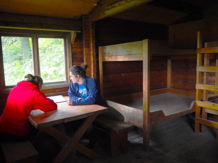 Two people at the table inside Sergief Island Cabin Enjoying Sergief Island Cabin