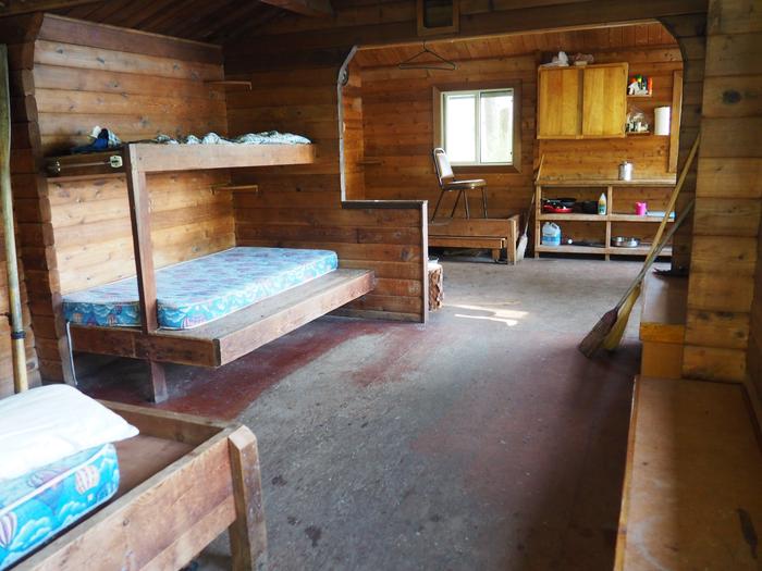 Virginia Lake Cabin interior with wood bunks and mattressesVirginia Lake Cabin interior