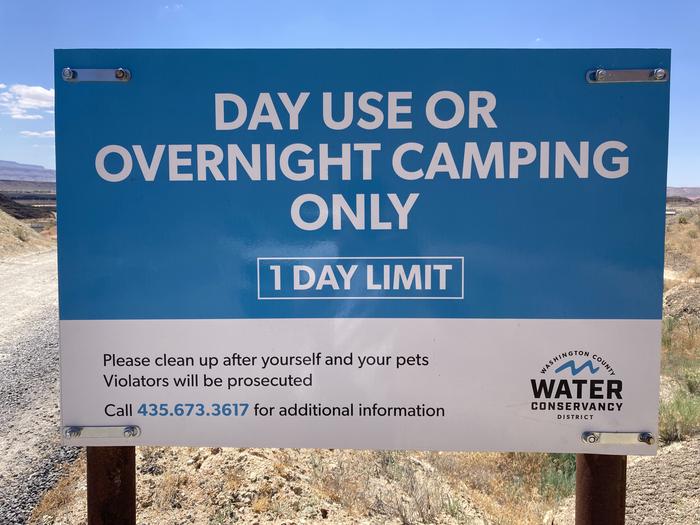 Washington County Water Conservancy entrance signOfficial Washington County Water Conservancy entrance sign states, “Day use or overnight camping only. One day limit. Please clean up after yourself and your pets. Violators will be prosecuted. Please call 435-673-3617 for additional information.