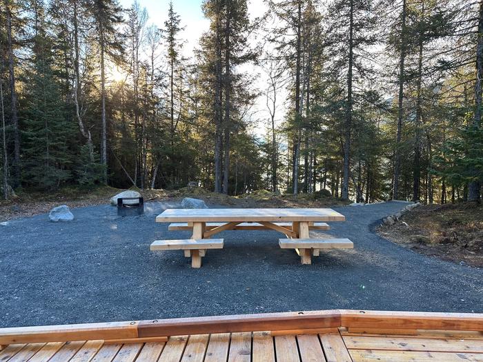 Trail River Cabin picnic table and fire ring overlooking Kenai Lake. 