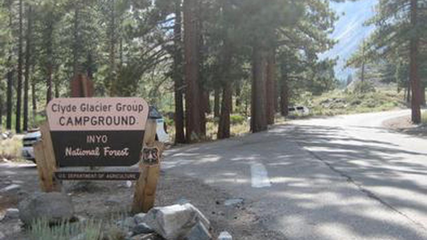 A Forest Service brown and yellow sign on the side of a roadBig Pine Canyon