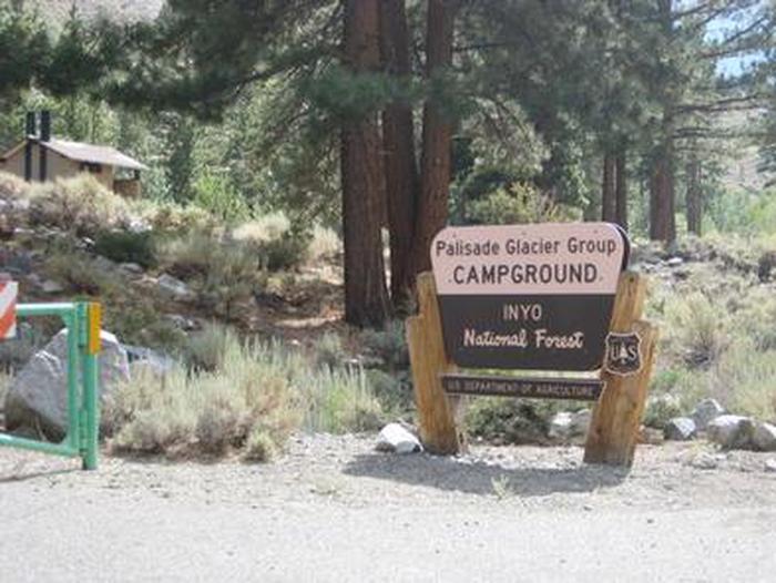 A Forest Service brown and yellow sign on the side of a roadBig Pine Canyon