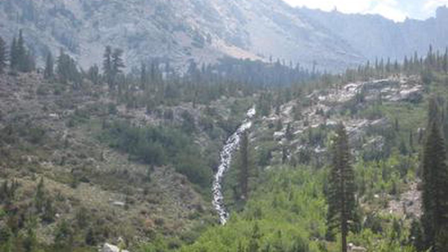 A waterfall streams down into a mountain valleyOnion Valley