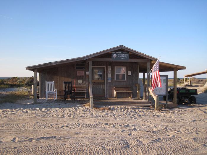 The sandy entrance to the Long Point Cabin Camp Office with beach dune in the backgroundPurchase ice or gasoline and learn about the island and park rules at the Long Point Cabin Camp Office