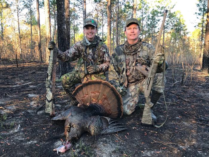 A father and son pose with their harvested wild turkey at the Carolina Sandhills National Wildlife Refuge.Two hunters display harvested turkeys at the refuge check station.