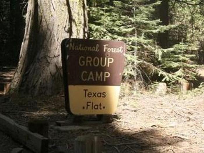 A brown and yellow Forest Service sign for Texas Flats Group CampTexas Flats Group Camp