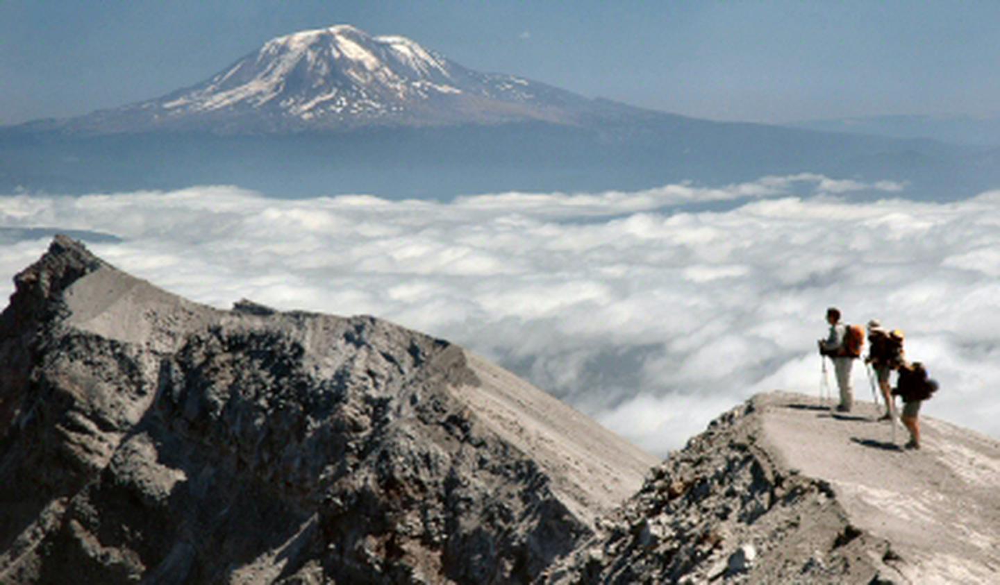 Climbers on the rim of Mount St Helens, Mount Adams in the backgroundClimbers on the rim