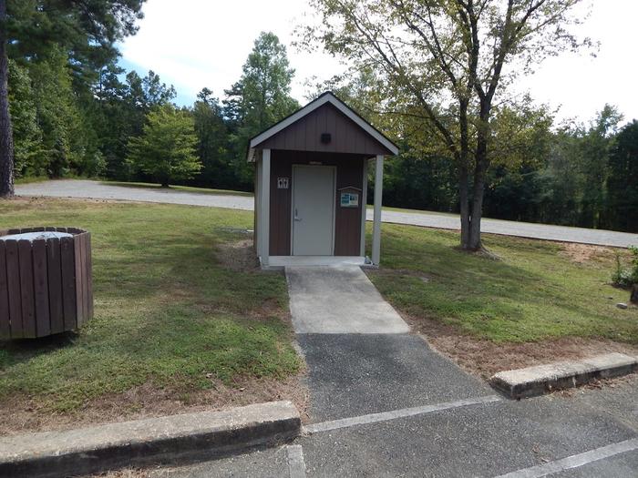 This is a vault toilet that can be found near the boat ramp. This is a vault toilet that is located near the boat ramp.