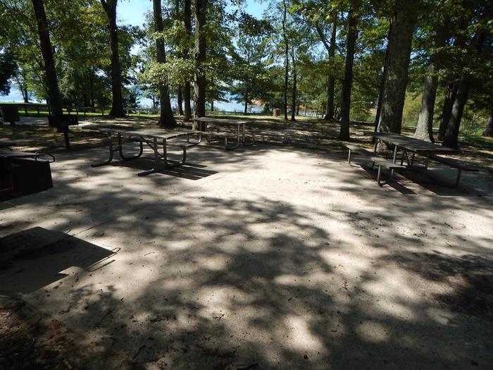 Accessible picnic areaIn this picture there are accessible picnic tables and grills. They are on a concreted pad with an accessible restroom near by. These are located near the OSAGE picnic shelter. 