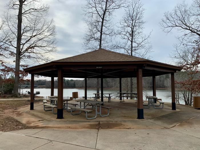 Rudds Creek Picnic shelterThis is the picnic shelter located in the Rudds Creek Day Use Area. There are picnic tables located under the covered shelter. There is a large grill located on the side of the building. There are trash cans located throughout the park. 