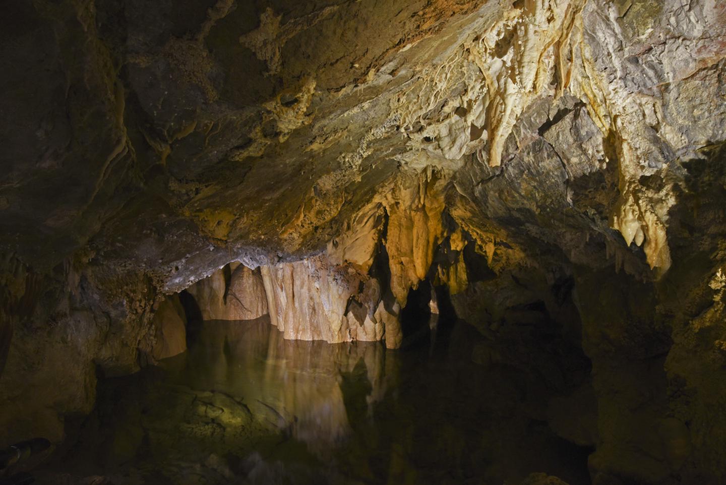 Clear cave lake surrounded by stalactites and other formationsMiddle Cave Lake