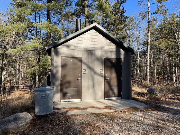 A photo of a vault toilet and trash facility at Island lake (MI)