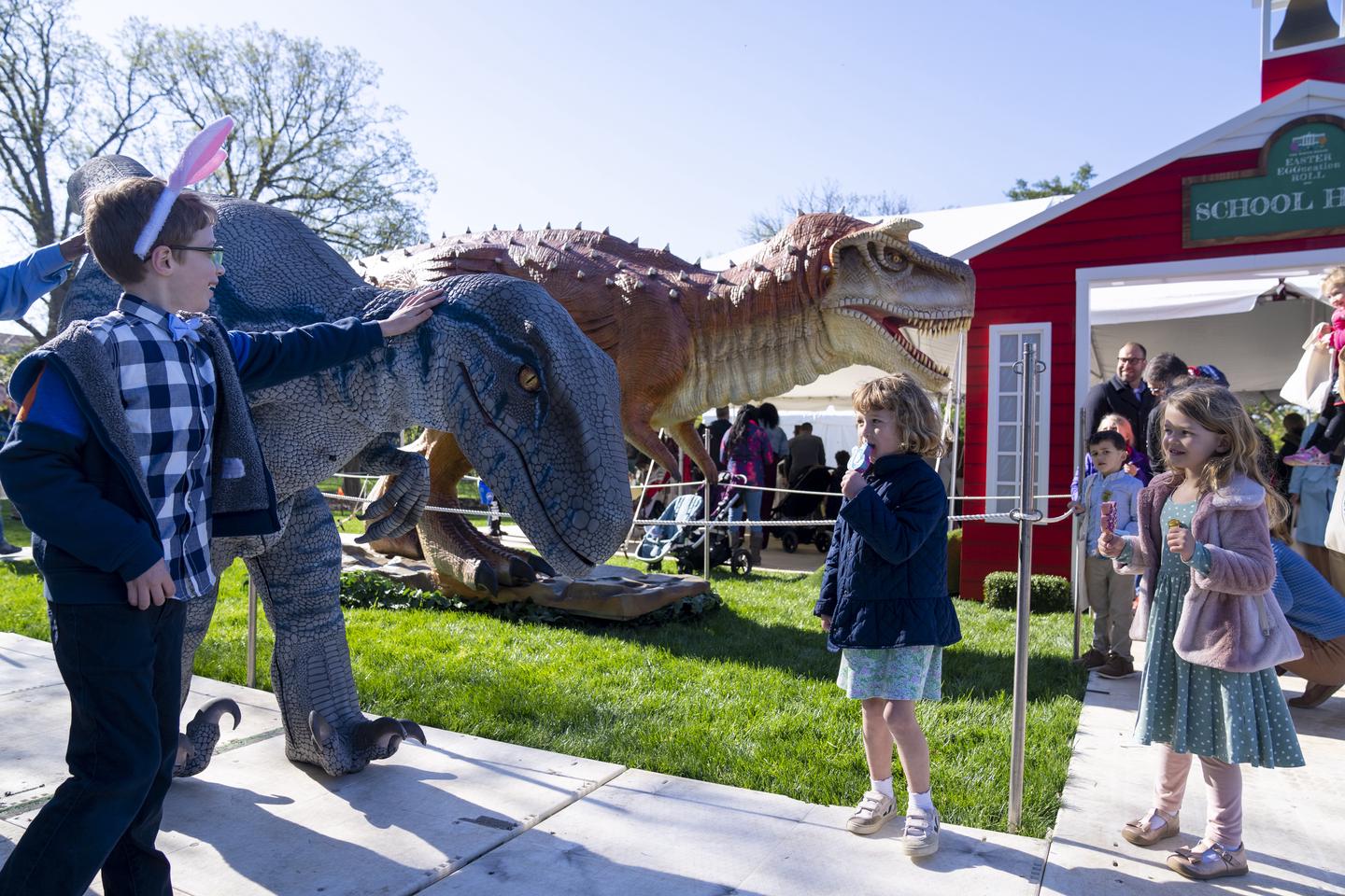 Children participating in dinosaur exhibition during White House Easter Egg Roll
