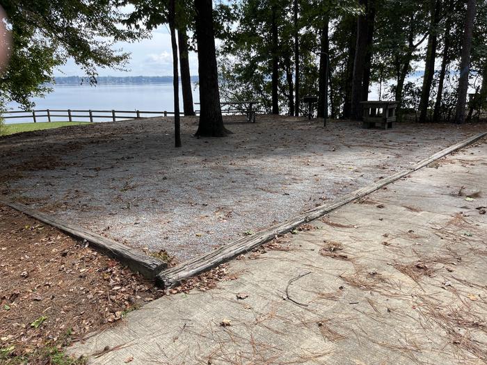 A photo of Site 118 of Loop RCHA at WHITE OAK (CREEK) CAMPGROUND with Picnic Table, Electricity Hookup, Fire Pit, Shade, Waterfront, Lantern Pole, Water Hookup