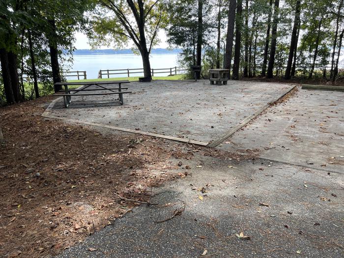 A photo of Site 119 of Loop RCHA at WHITE OAK (CREEK) CAMPGROUND with Picnic Table, Electricity Hookup, Fire Pit, Shade, Waterfront, Lantern Pole, Water Hookup