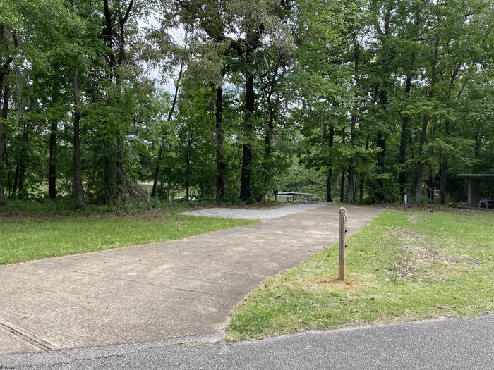 A photo of Site 021 of Loop PRAIRIE CREEK (AL) at PRAIRIE CREEK (AL) with Picnic Table, Electricity Hookup, Fire Pit, Shade, Waterfront, Lantern Pole