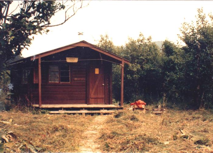 Koknuk cabin photo taken in 1987 showing wood cabin and trail leading to itKoknuk Cabin 1987
