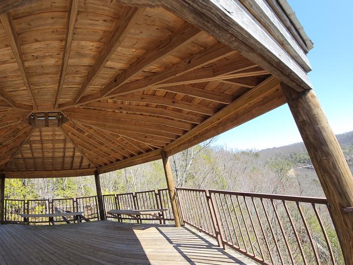 The sun casts a shadow onto the decking of the gazebo that overlooks a canyon.The overlook at the gazebo.