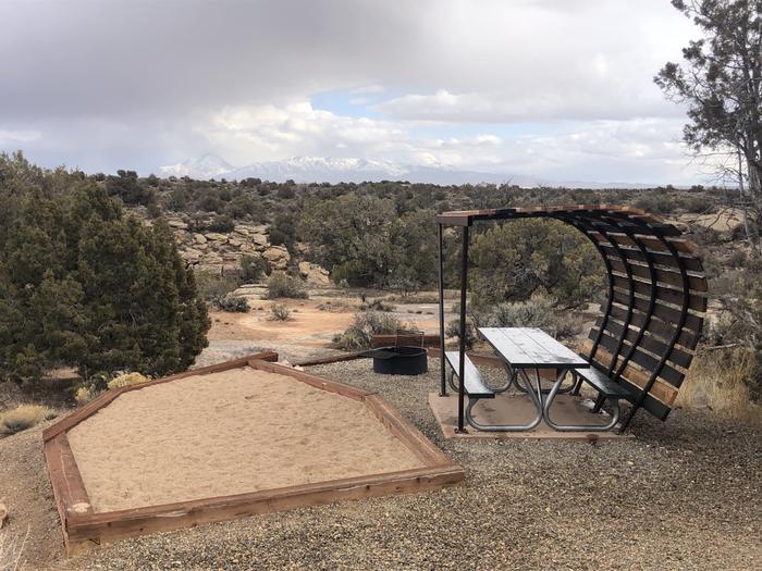 Tent pad, picnic table, and fire ring at Site 15