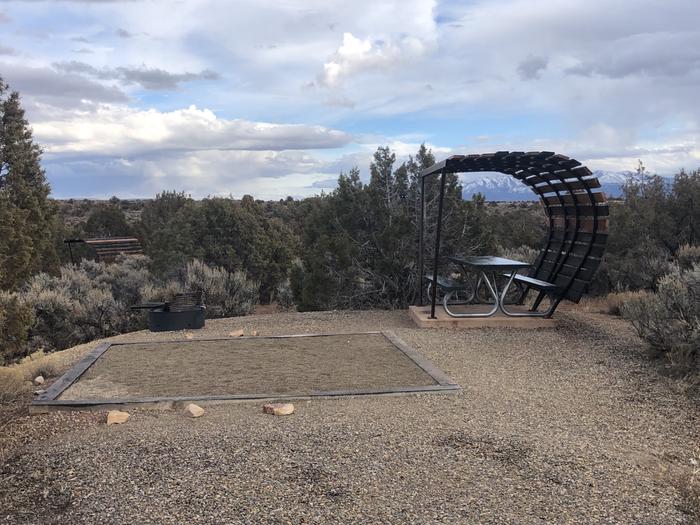 Tent pad, picnic table, and fire ring at Site 26