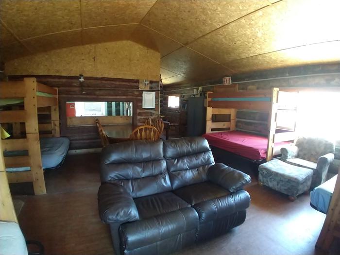 Living quarters, with leather loveseat, fabric chair with ottoman, 4 sets of bunkbeds (bottom is full size, top is single) 