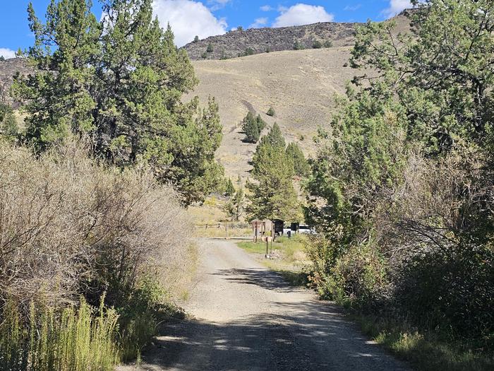 Campground loop roadView of Chukar Park Campground loop road with fee station and hillside beyond.