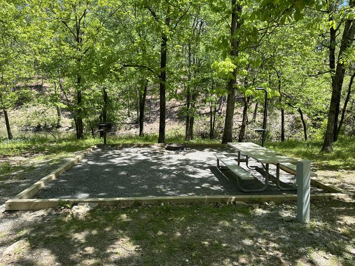 A photo of Site 02 of Loop A at Crystal Springs (AR) with Picnic Table, Electricity Hookup, Fire Pit, Tent Pad, Lantern Pole