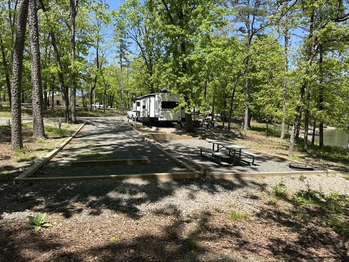 A photo of Site 06 of Loop A at Crystal Springs (AR) with Picnic Table, Electricity Hookup, Fire Pit, Water Hookup
