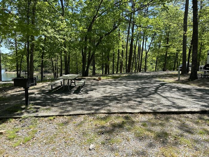 A photo of Site 12 of Loop A at Crystal Springs (AR) with Picnic Table, Electricity Hookup, Fire Pit, Water Hookup