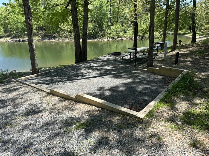 A photo of Site 13 of Loop A at Crystal Springs (AR) with Picnic Table, Electricity Hookup, Fire Pit, Tent Pad, Lantern Pole, Water Hookup